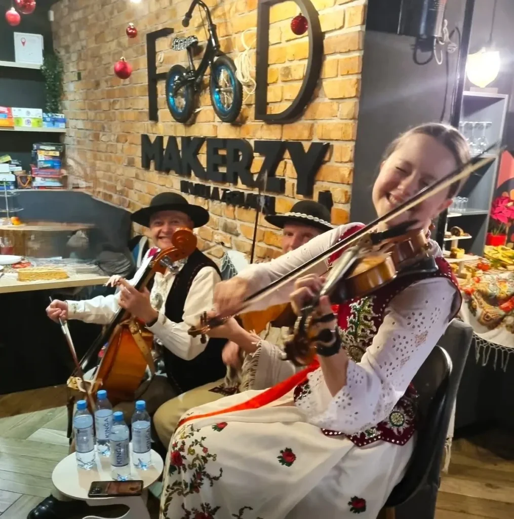 Zespół ludowy grający kolędy, zapewniający świąteczną atmosferę podczas bożego narodzenia w górach.